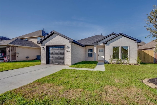 ranch-style home featuring a front yard and a garage