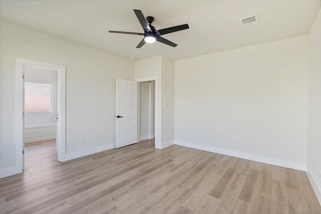 unfurnished bedroom with ensuite bath, ceiling fan, and light hardwood / wood-style floors