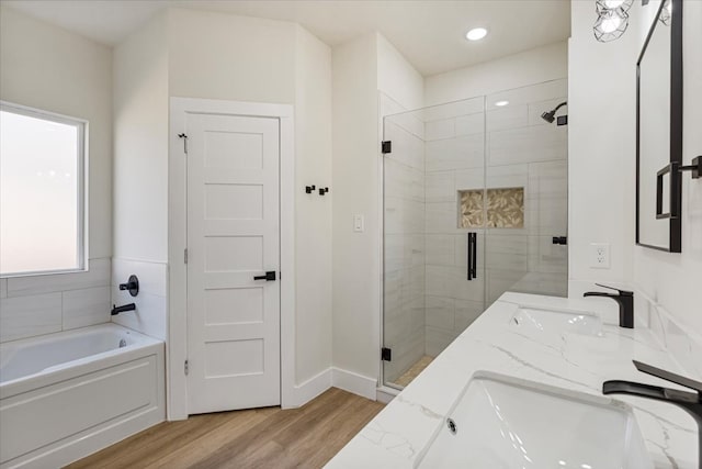 bathroom with wood-type flooring, vanity, and separate shower and tub