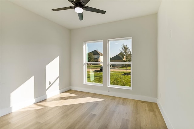 spare room with ceiling fan and light wood-type flooring