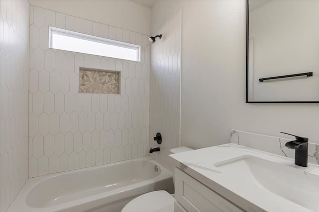 full bathroom with vanity, tiled shower / bath combo, and toilet