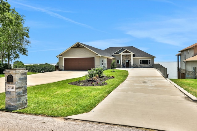 view of front of home with a front lawn and a garage