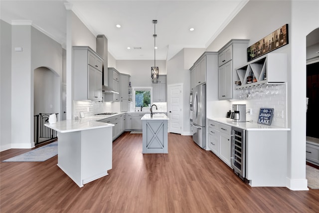 kitchen featuring beverage cooler, dark wood-type flooring, pendant lighting, gray cabinets, and stainless steel refrigerator