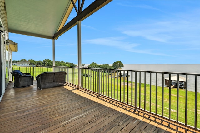 wooden deck featuring a water view and a lawn