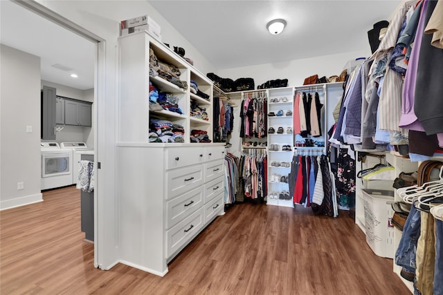 walk in closet with washer and dryer and wood-type flooring