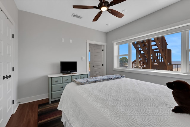 bedroom featuring ceiling fan and dark wood-type flooring