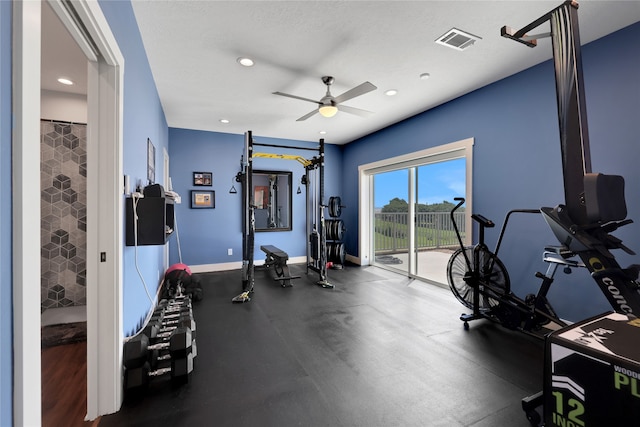 exercise room featuring ceiling fan and a textured ceiling