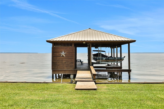 dock area featuring a water view and a lawn