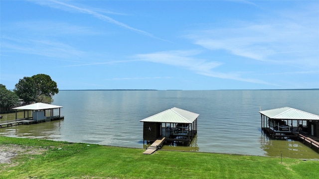 dock area with a yard and a water view