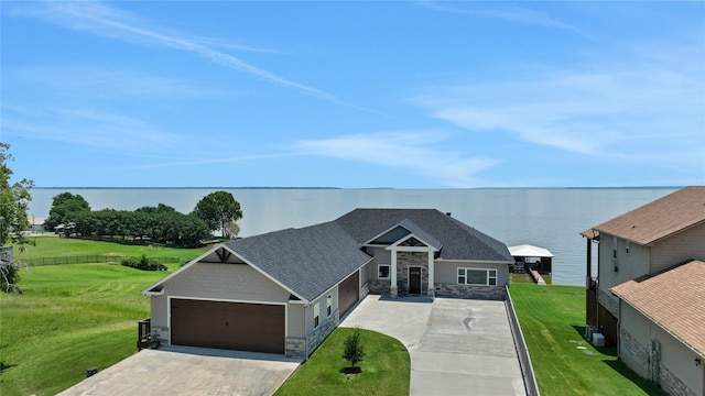 view of front of house featuring a garage and a water view