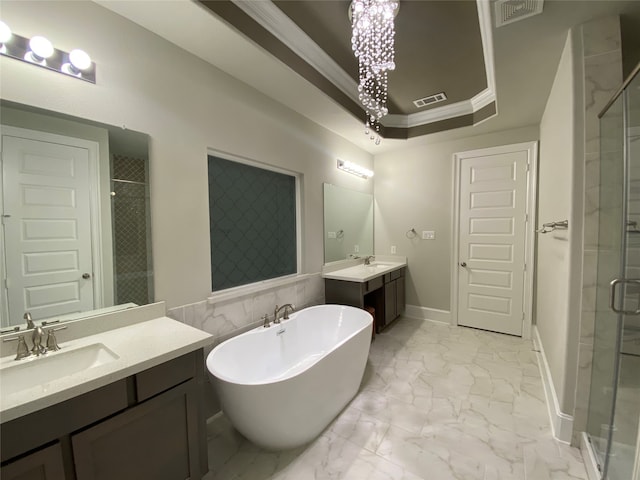 bathroom featuring separate shower and tub, a raised ceiling, vanity, and ornamental molding