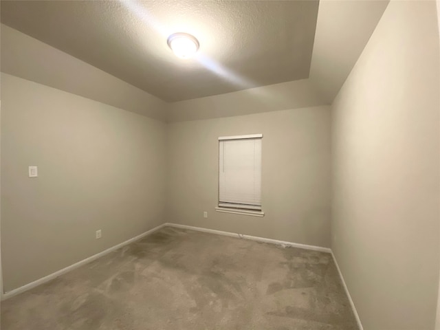 carpeted spare room with a textured ceiling