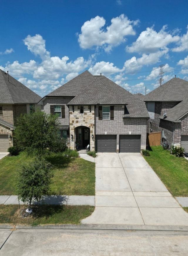 view of front of house with a front yard and a garage