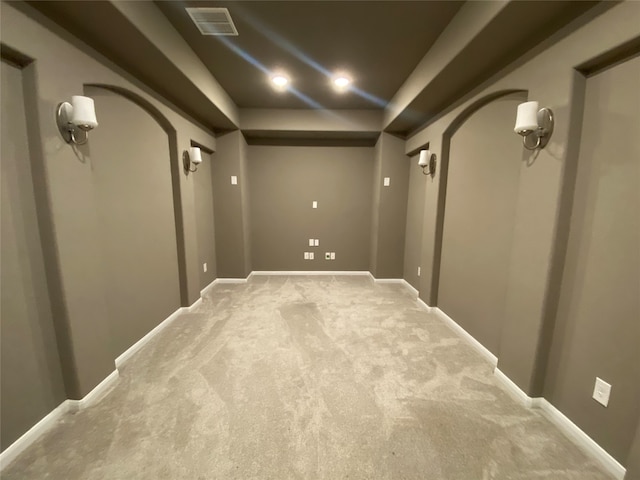 cinema room featuring light colored carpet