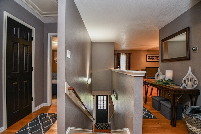 foyer entrance featuring wood-type flooring and a textured ceiling