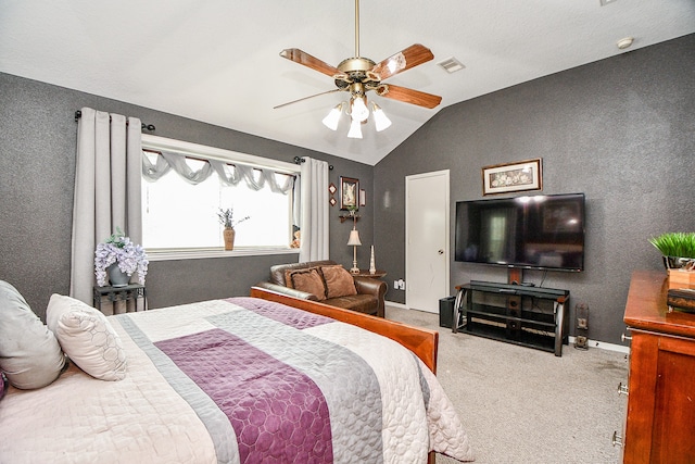 carpeted bedroom with ceiling fan and vaulted ceiling