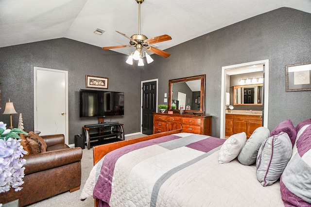 bedroom with carpet flooring, ceiling fan, sink, ensuite bathroom, and lofted ceiling