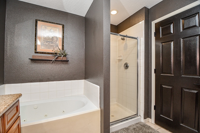 bathroom featuring tile patterned flooring, vanity, shower with separate bathtub, and a textured ceiling