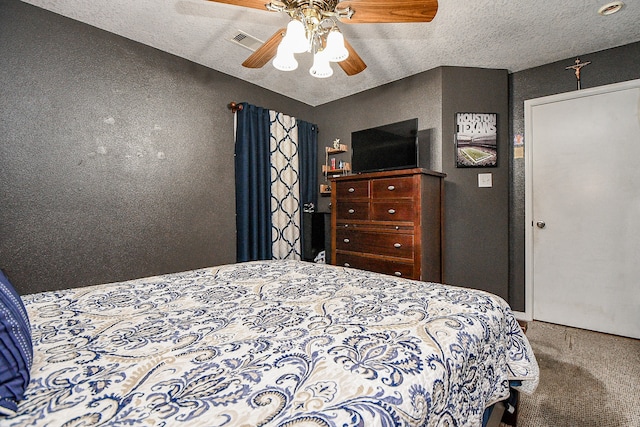 carpeted bedroom with a textured ceiling and ceiling fan