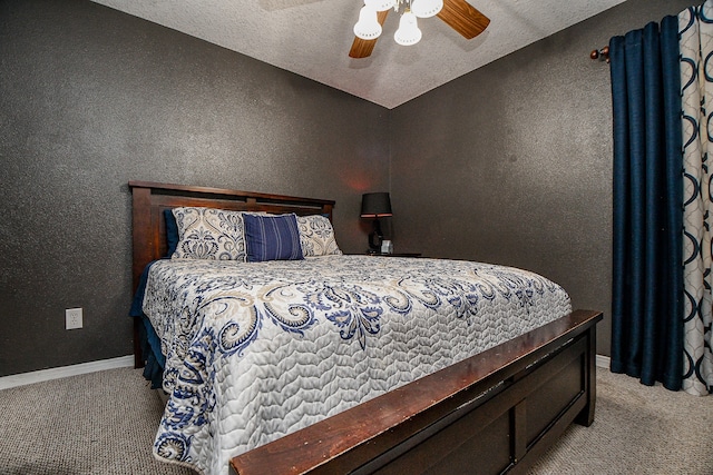 bedroom featuring light carpet, a textured ceiling, and ceiling fan