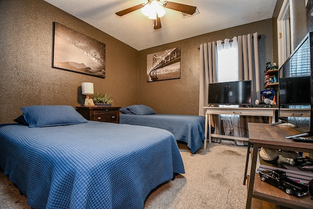 bedroom with carpet, ceiling fan, and a textured ceiling