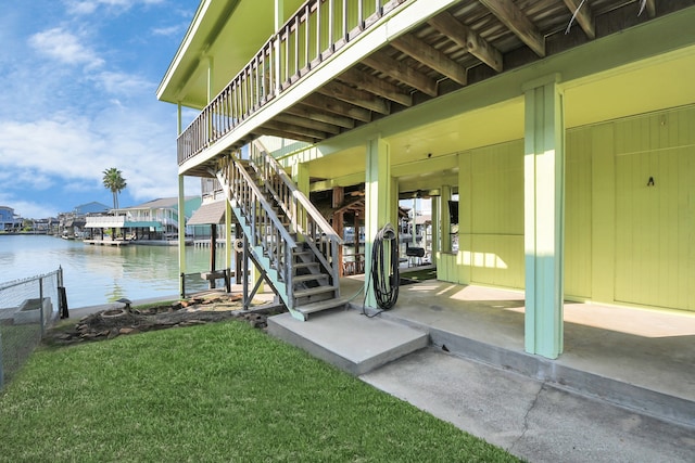 dock area with a yard and a water view