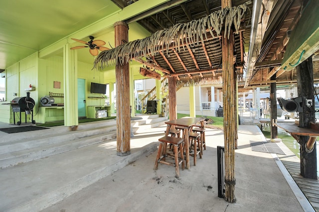 view of patio / terrace with ceiling fan and a grill