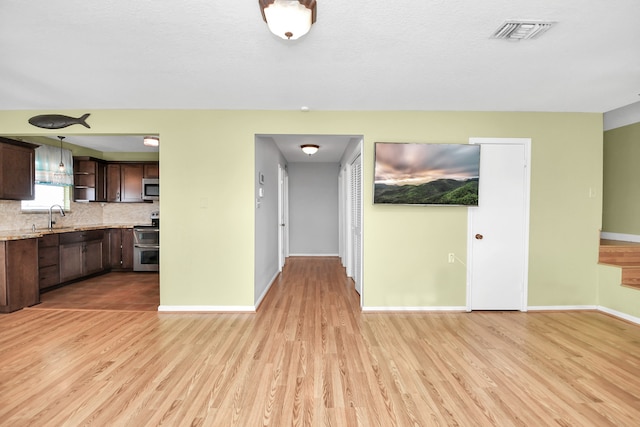 interior space with light hardwood / wood-style flooring and sink