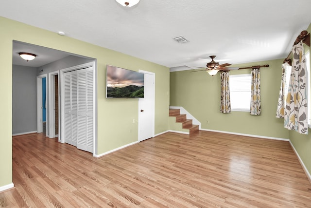 unfurnished room featuring ceiling fan and light wood-type flooring