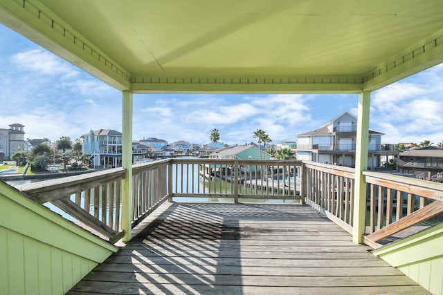 wooden terrace featuring a water view