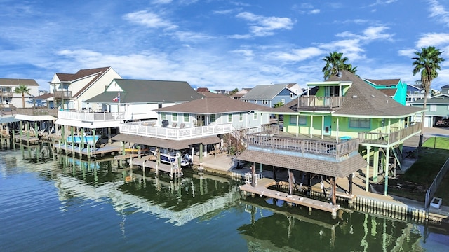 view of dock with a deck with water view and a balcony