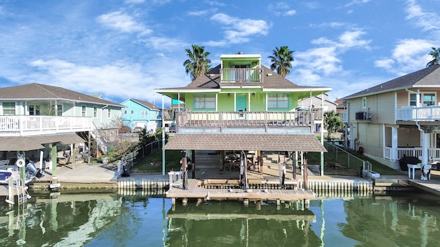 view of dock with a balcony and a water view