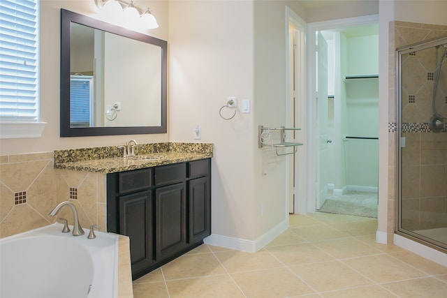 bathroom featuring tile patterned floors, vanity, and shower with separate bathtub