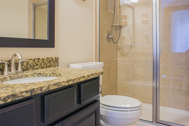 bathroom featuring vanity, toilet, and walk in shower