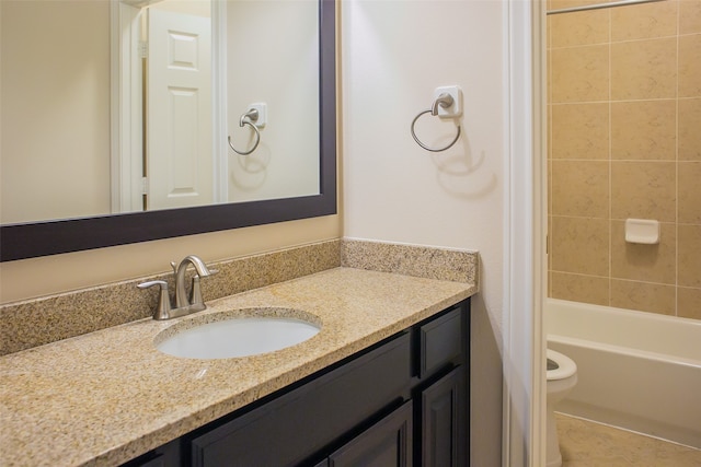 full bathroom with vanity, toilet, and tiled shower / bath