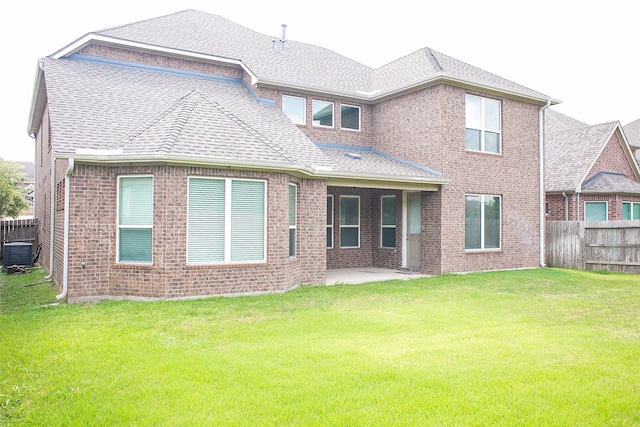 rear view of property with central air condition unit, a patio area, and a lawn