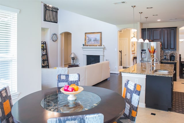 tiled dining room featuring sink