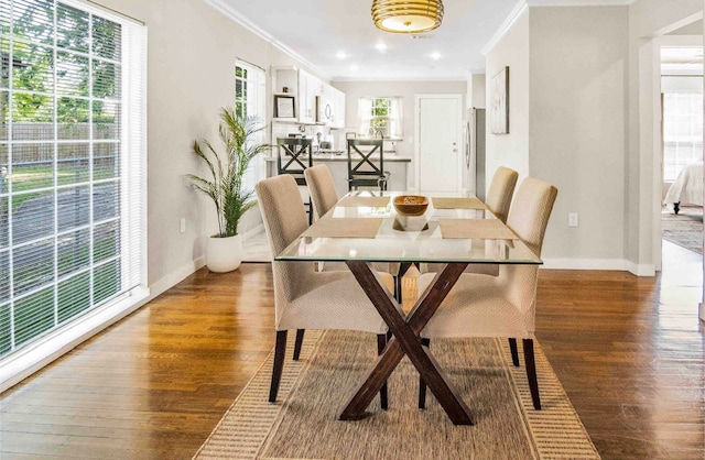 dining room with ornamental molding and dark wood-type flooring