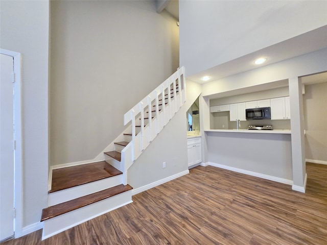 stairway featuring hardwood / wood-style floors