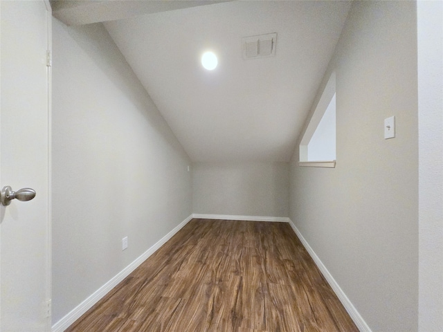 bonus room with hardwood / wood-style floors and vaulted ceiling