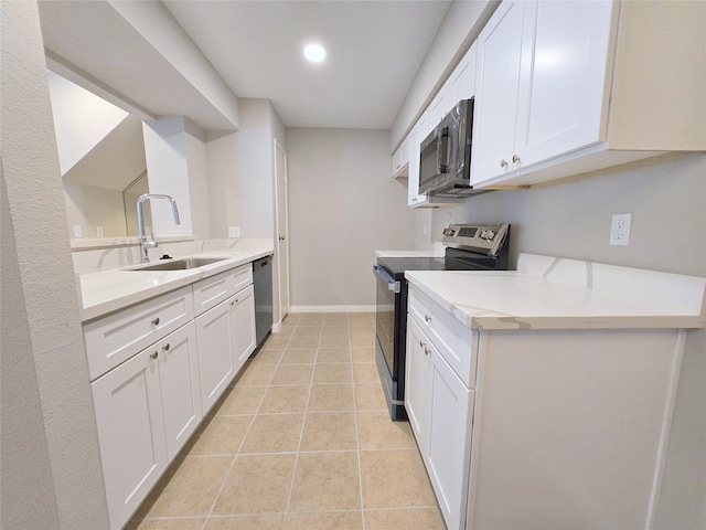 kitchen featuring white cabinets, appliances with stainless steel finishes, light tile patterned floors, and sink