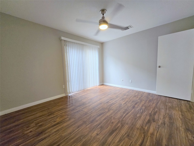 unfurnished room with ceiling fan and dark hardwood / wood-style flooring