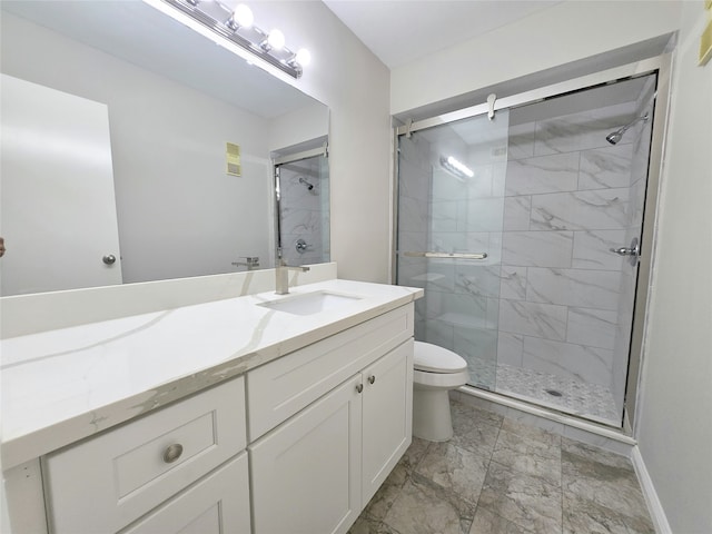 bathroom with vanity, toilet, and a shower with shower door