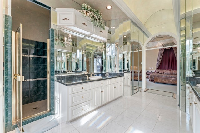 bathroom with tile patterned flooring, vanity, and a shower with door