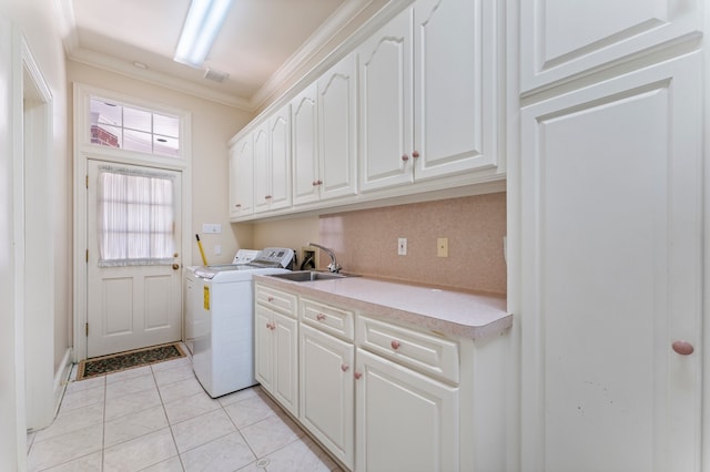 clothes washing area with washing machine and clothes dryer, sink, cabinets, light tile patterned floors, and ornamental molding