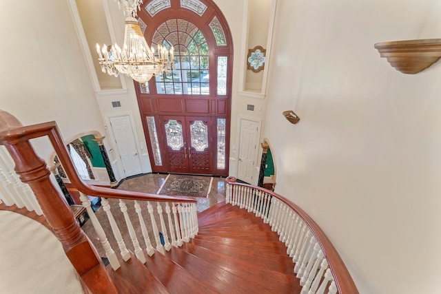 foyer featuring a chandelier, a high ceiling, and hardwood / wood-style flooring