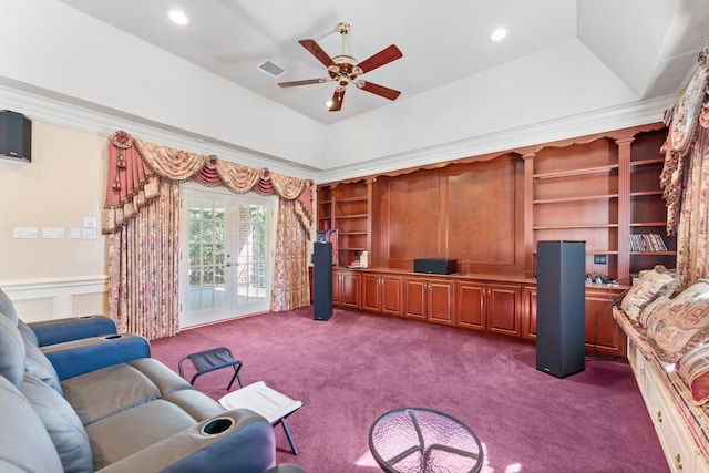 carpeted living room featuring ceiling fan, a tray ceiling, and french doors