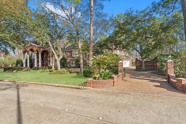 view of front of home with a front yard and a garage