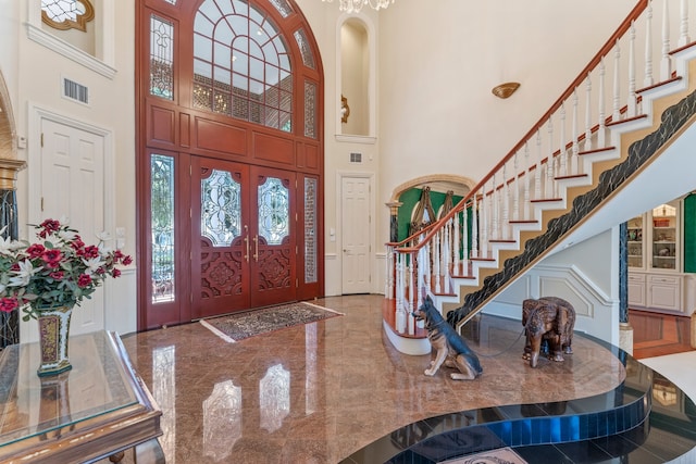 entrance foyer with a high ceiling and french doors