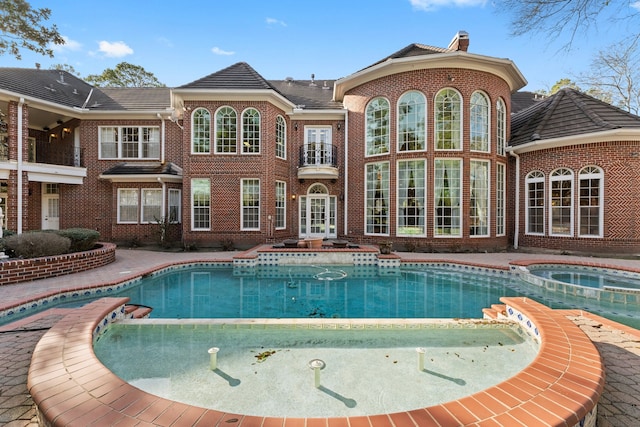 view of pool featuring an in ground hot tub and french doors